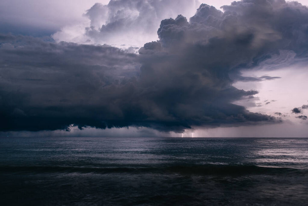 спалах блискавки в нічному небі над морем
 - Фото, зображення