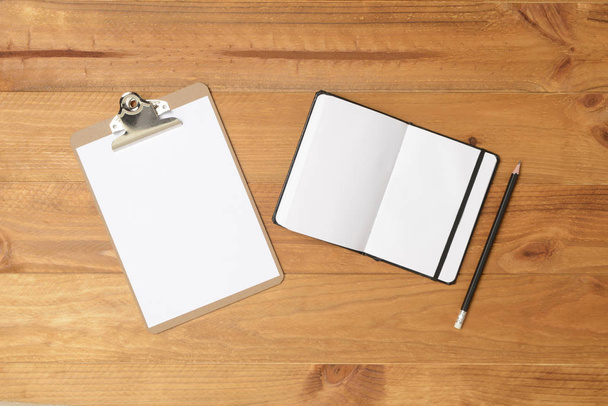 Notebook, folder and pen on wooden floor. Brown wood. - Zdjęcie, obraz