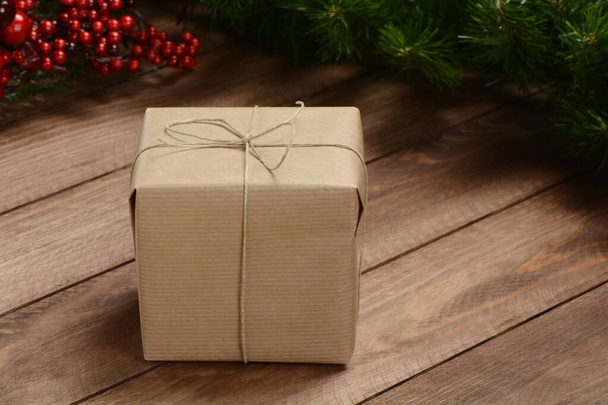 Gifts box on wooden background and green and red garland,  - Fotó, kép