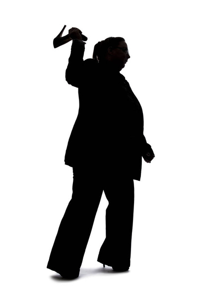 Silhouette of a curvy or plus size businesswoman on a white background for composites.  She is hitting something with heels of shoes - Foto, imagen