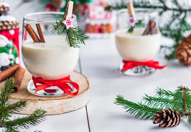 Traditional eggnog Christmas cocktail in a glass goblet decorated with New Year clothespin. Non-alcoholic option. - Foto, Imagem
