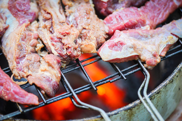 Roast beef sliced meat steaks on the grill with flames - Grilled - Photo, Image