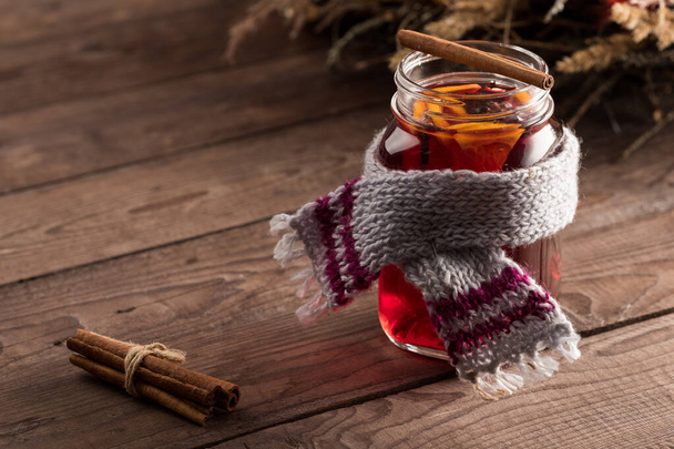 Fragrant drink of Christmas mulled wine with oranges and spices on a wooden background. Selective focus. Copy space - Фото, зображення