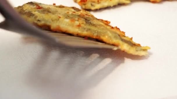 puts fish flounder on a napkin. Fried fish, dripping fat. Homemade food - Video