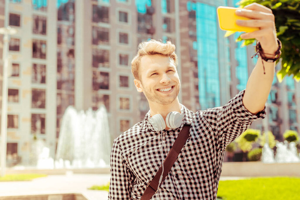 Positive delighted blonde man doing selfie photo - Photo, image