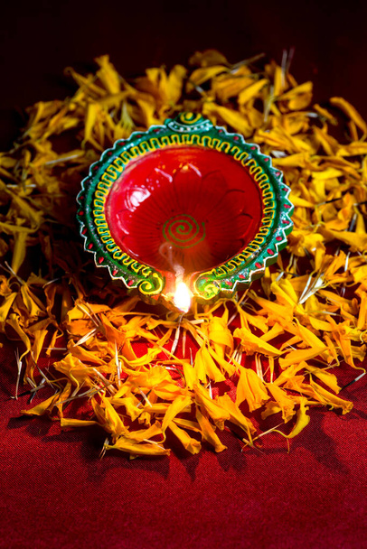 Happy Diwali - Clay Diya lamps lit during Diwali celebration. Greetings Card Design of Indian Hindu Light Festival called Diwali - Фото, изображение