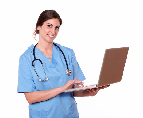 Nurse smiling while using her laptop - Fotoğraf, Görsel