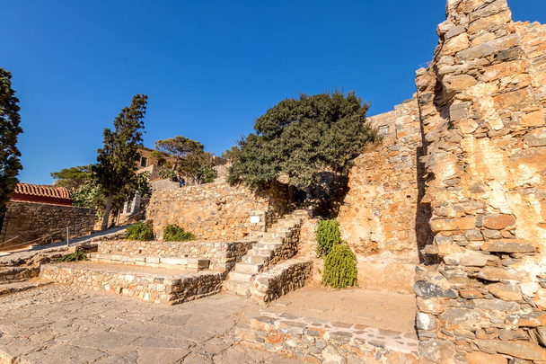 Old buildings and ruins of Spinalonga on a sunny day. - Photo, Image