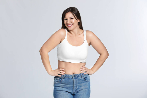 Young body positive woman on grey background - Photo, Image