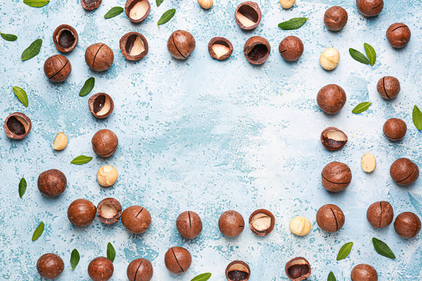 Frame made of macadamia nuts on color background - Foto, imagen