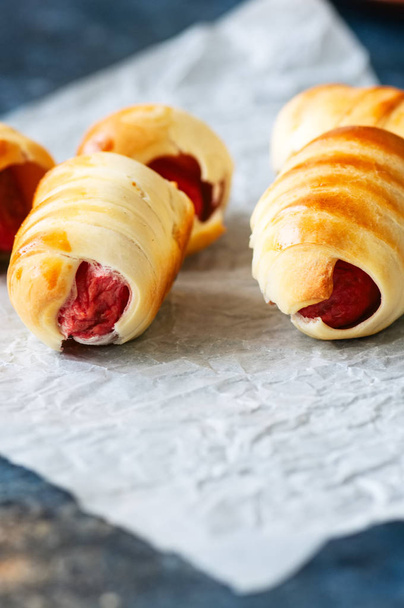 Pigs in a blanket on a baking paper. Close up. - Фото, изображение