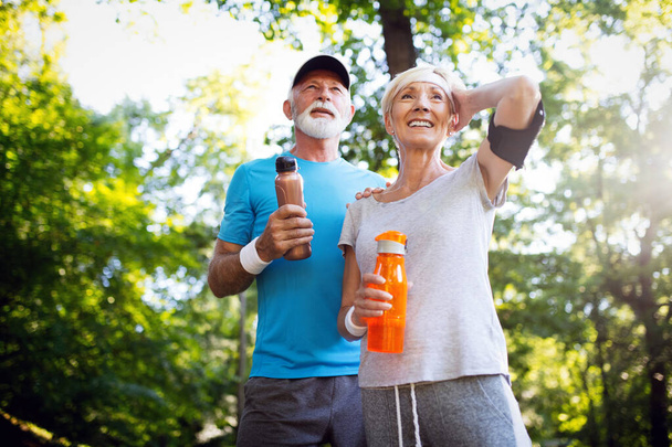 Happy senior people couple exercising for healthy life - Fotó, kép