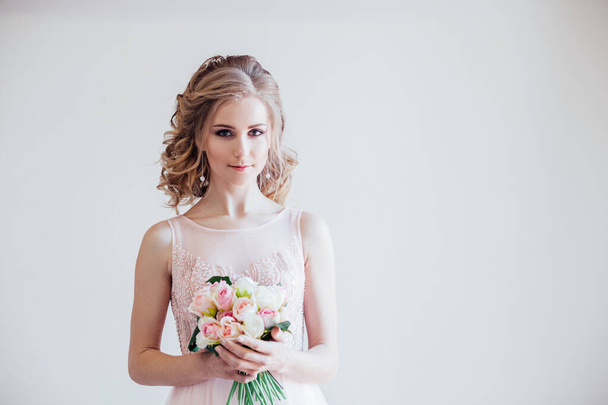 bride in wedding dress holding a bouquet of flowers - Photo, Image