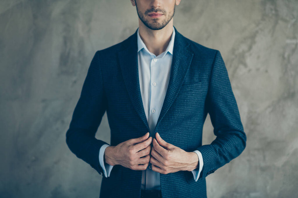 Cropped photo of white clever business people standing confidently fastening his blazer with stubble on face isolated grey color background - Фото, изображение