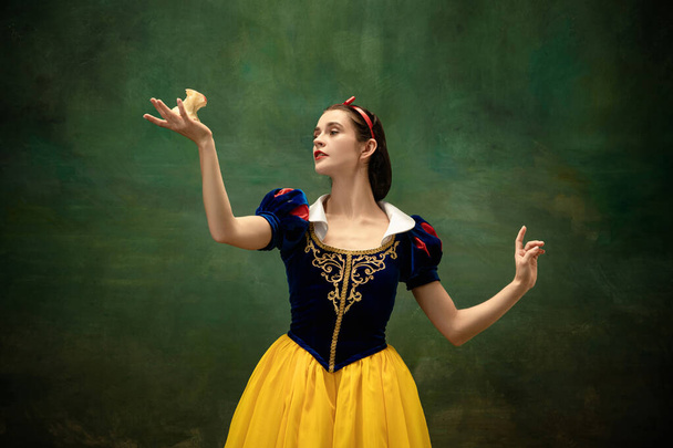 Young ballet dancer as a Snow White with poisoned apple in forest - Fotó, kép