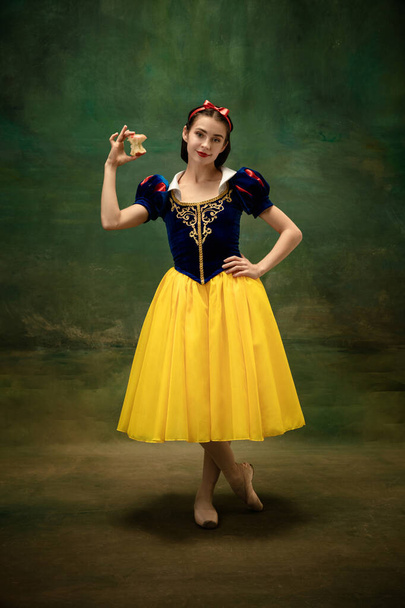 Young ballet dancer as a Snow White with poisoned apple in forest - Fotó, kép