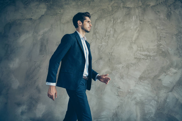 Profile side photo of serious concentrated businessman hurry for partnership meeting go walk ready to choose choice decide solution wear stylish outfit isolated over grey color background - 写真・画像