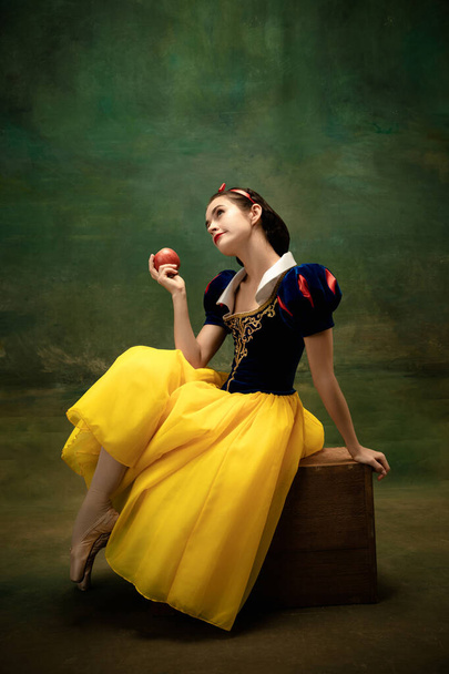 Young ballet dancer as a Snow White with poisoned apple in forest - Zdjęcie, obraz