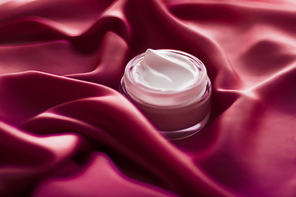 Face cream moisturizer jar on silk background, moisturizing skin - Photo, Image