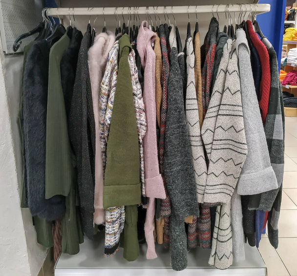 Warm winter cardigan coats clothes for casual styling an outdoor wearing organized and hanged in a shop - Photo, Image