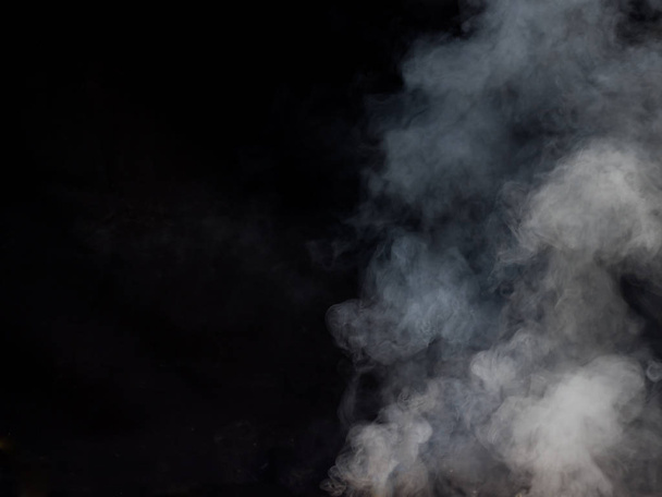 Light smoke texture on a dark background. Studio photography - Valokuva, kuva