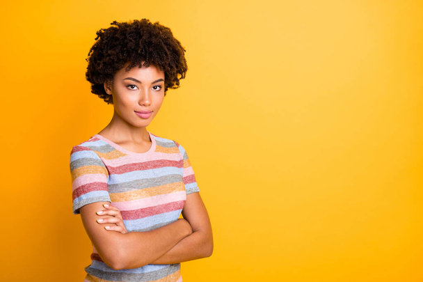 Photo of amazing dark skin business lady holding arms crossed reliable person wear casual striped t-shirt and trousers isolated on yellow background - Zdjęcie, obraz