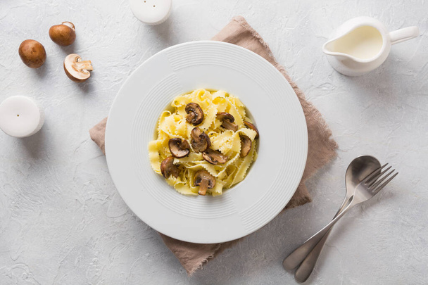 Spaghetti reginelle pasta with mushrooms on white. Tasty healthy dinner. - Fotografie, Obrázek