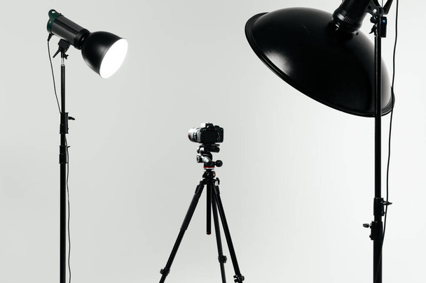 Photo studio with lighting equipment and camera - Photo, Image