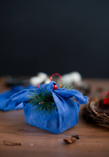 Christmas furoshiki wrapping. Etnical hristmas gift. Zero waste concept - Photo, Image