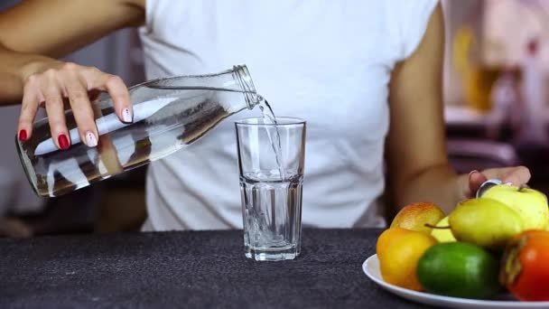 Close up woman hands pours pure water into glass - Footage, Video