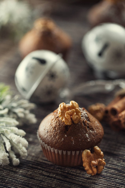 Christmas chocolate delicious muffins sprinklad with sugar powder and wallnut on top - Foto, immagini