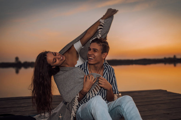 Young couple enjoying in a romantic date by the river, covered w - Foto, Imagen