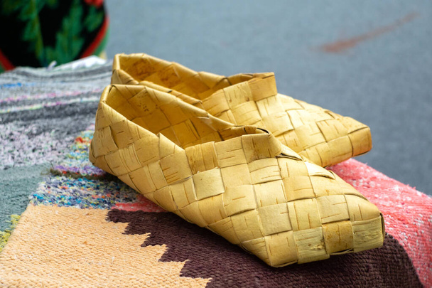 Russian national shoes bast shoes made of tree bark - Фото, изображение