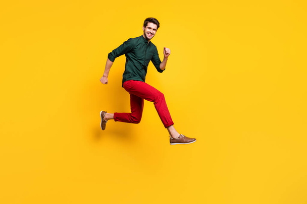 Full length body size photo of cheerful positive nice cute guy running towards shopping mall isolated vivid color background - Foto, imagen