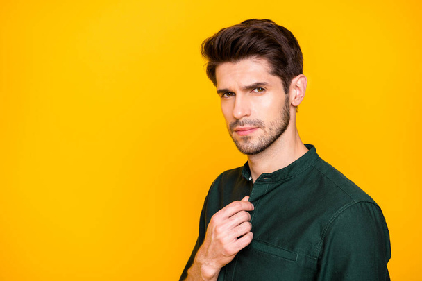 Photo of confident thoughtful man adjusting buttons on his shirt looking pensively into camera isolated vibrant color background - Foto, Imagem