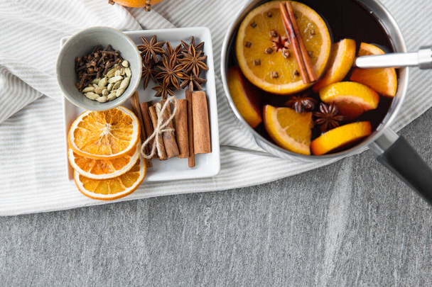 pot with hot mulled wine, orange slices and spices - Photo, image