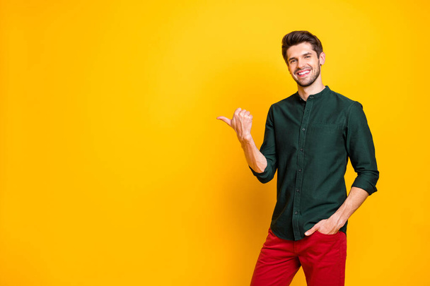 Attention here ads, Portrait of confident cool promoter guy feel positive cheerful expression point forefinger copyspace indicate direct promotion wear modern outfit isolated shiny color background - Photo, Image