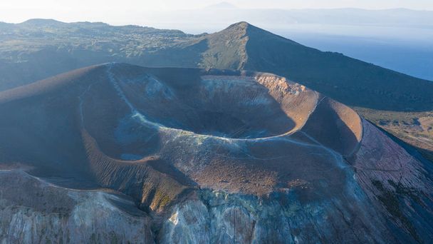Aerial view photo from flying drone of Amazing grand Vulcano crater with fumaroles on Island at sunrise. Of Vulcano, into Lipari ,Eolie Islands. Panoramic View of crater taken Italy, Sicily - Photo, Image
