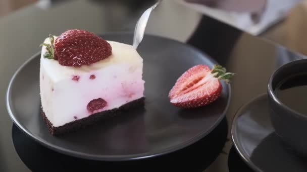 Piece of cake, woman eats cream fruit cake, cake and a cup of black coffee on a black glass table, - Footage, Video
