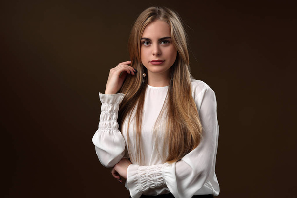 Beautiful girl with long hair in white blouse - Fotó, kép
