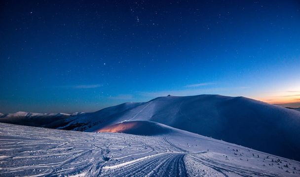 Empty ski resort under the moonlight at night - Photo, image