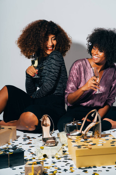 Two Happy American African Women celebrating new years eve at the pub. Female friends partying in nightclub. - Фото, зображення