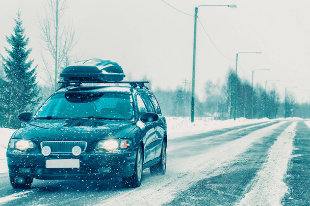Car with roof luggage rack at road in Finland - Photo, Image