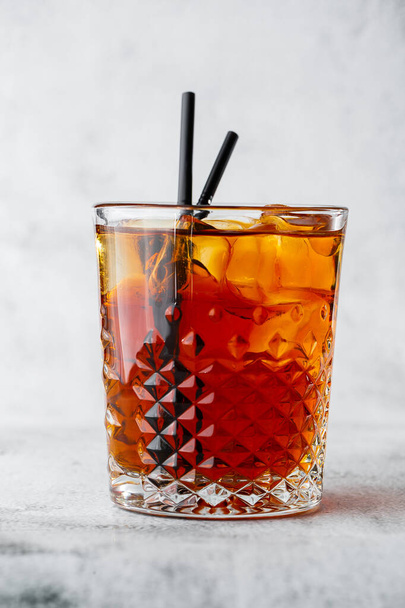 Glasse of iced black tea with lemon, overhead view. isolated on bright marble background. Overhead view, copy space. Advertising for cafe menu. Coffee shop menu. Vertical photo. - Photo, image