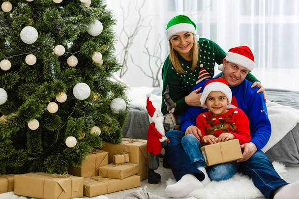 Mother, father and son celebrating Christmas together at home - Foto, imagen