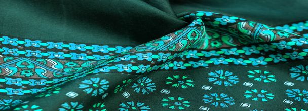 silk fabric of green color with blue and white flowers, dense fa - Photo, Image