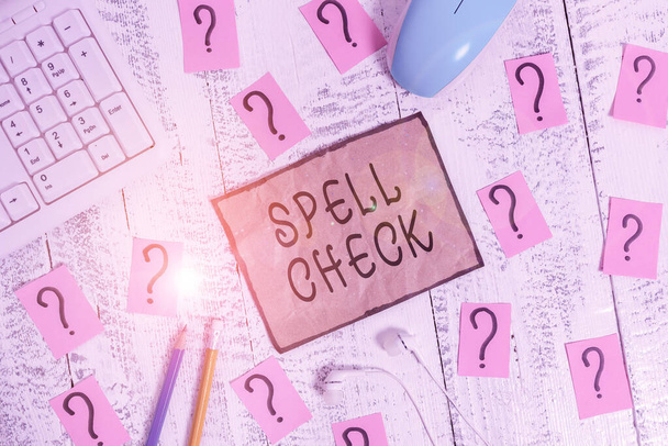 Conceptual hand writing showing Spell Check. Business photo showcasing to use a computer program to find and correct spelling errors Writing tools and scribbled paper on top of the wooden table. - Photo, Image
