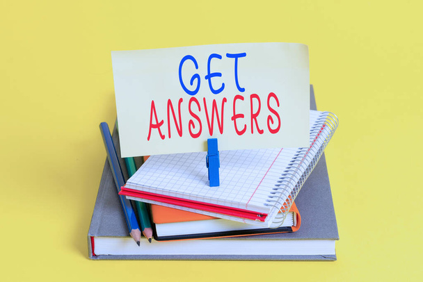 Conceptual hand writing showing Get Answers. Business photo showcasing to get a reply or something when asks a question to someone Book pencil rectangle shaped reminder notebook clothespins. - Photo, Image