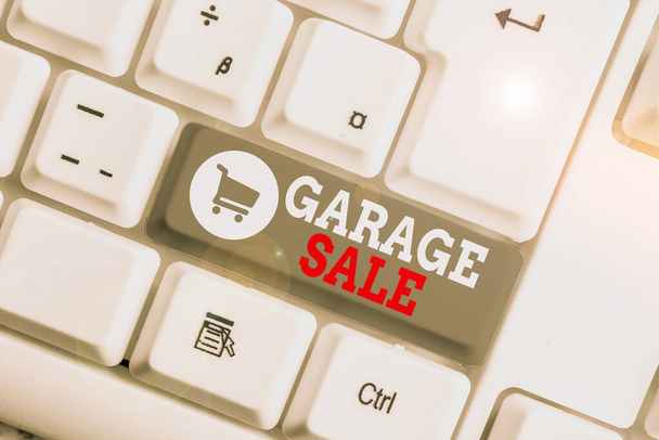 Conceptual hand writing showing Garage Sale. Business photo showcasing sale of miscellaneous household goods often held in the garage White pc keyboard with note paper above the white background. - 写真・画像