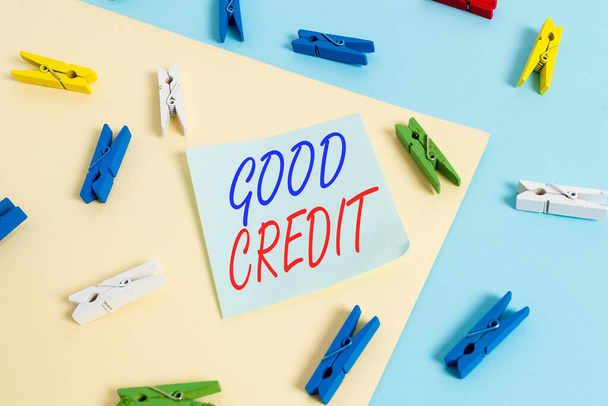 Text sign showing Good Credit. Conceptual photo borrower has a relatively high credit score and safe credit risk Colored clothespin paper empty reminder yellow blue floor background office. - Fotoğraf, Görsel